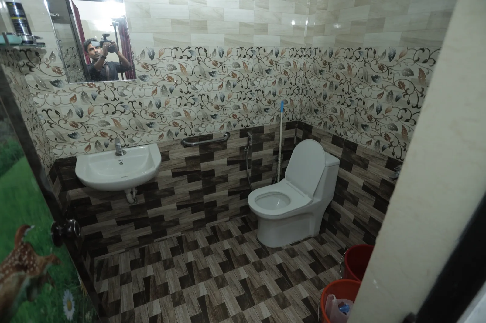 Tiled attached bathroom in a patient room at Agasthya Ayurvedic Hospital