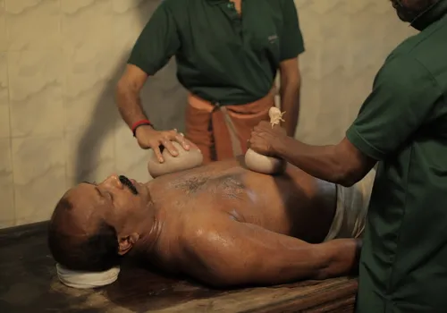 Ayurvedic kizhi therapy applied to the lower back for an L5-S1 disc bulge at Agasthya Ayurvedic Hospital Kerala
